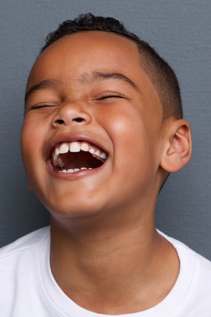 best funny jokes for kids from Kids Activities Blog - boy laughing out loud with eyes closed
