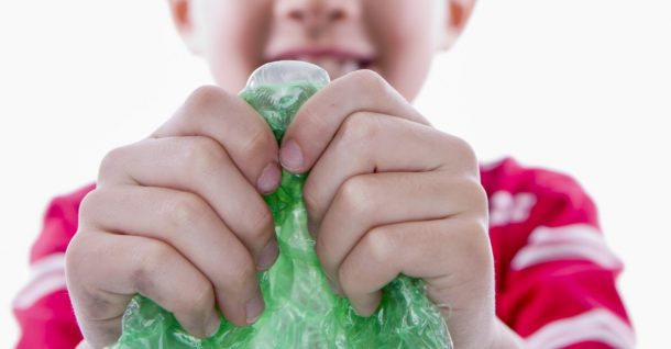 Boy making new years eve noise maker with colorful bubble wrap- new years eve activities- kids activities blog