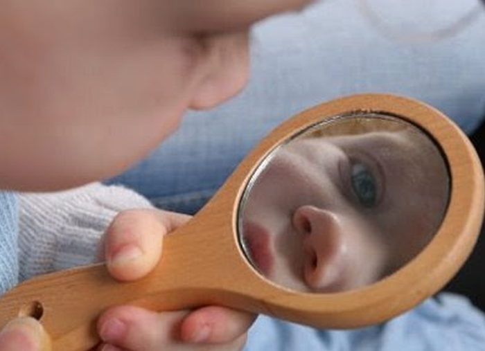 Circle Time Activities- Image shows a toddler looking at himself through a mirror. Idea from Teaching expertise