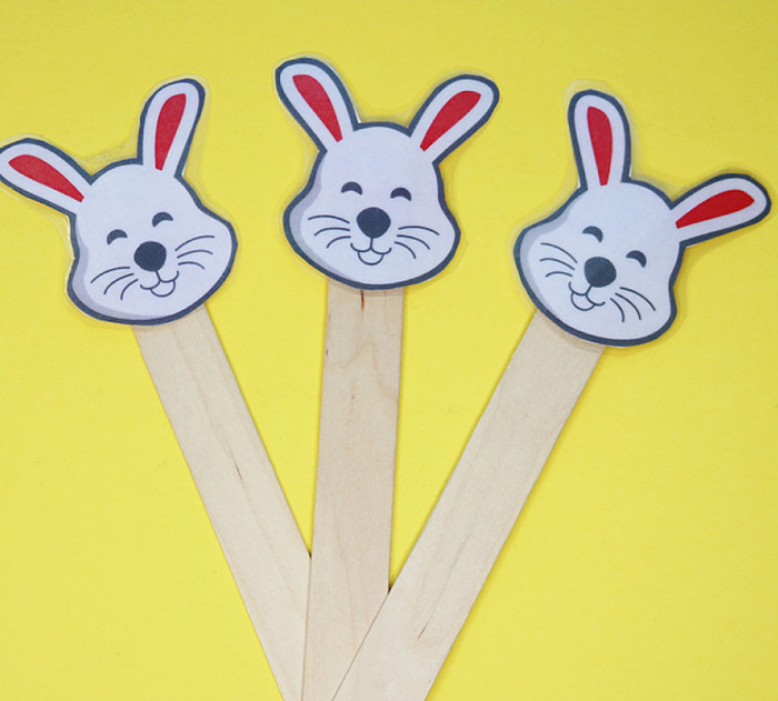 Circle Time Activities- Image shows three popsicle sticks with bunny head printables glued on top. Idea from Teaching 2 and 3 year olds