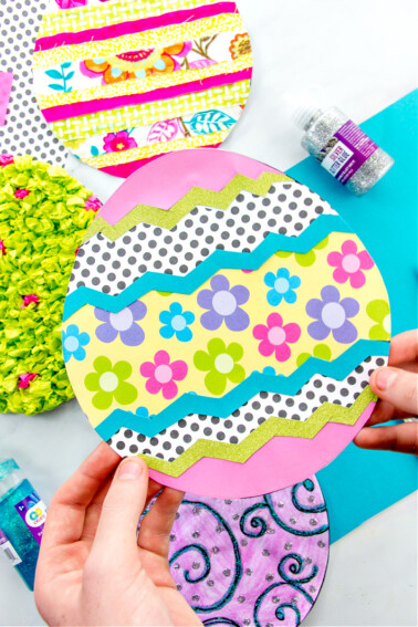 Colorful paper easter egg designs using coloring pages and scrap craft supplies.