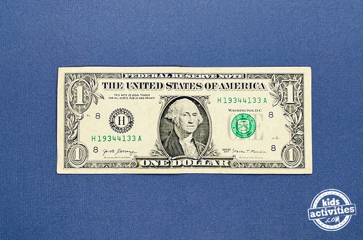 "Dollar bill origami pants - Step 1 - Take a crisp dollar bill