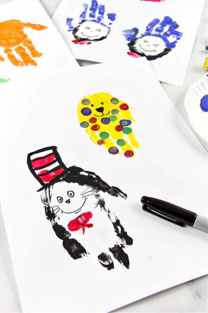 Cat in the Hat art made out of handprints and paint from Kids activities Blog shown on a white paper