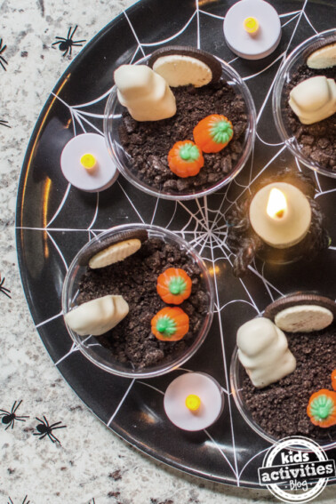 Scary Cute Halloween Pudding Cups for Kids on a platter at Halloween party