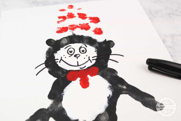 Cat in the hat finger painting with  finger print hat and bow tie and black sharpie tie