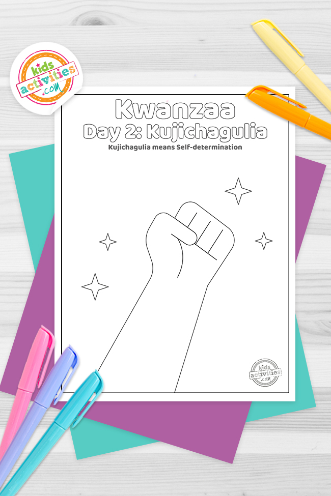 Kwanzaa Day 2 Coloring Pages Printed pdf version of black/white line drawing of a fist with sparkles around it with the text: Day 2: Kujichagulia- Kujichagulia means self-determination- kids activities blog