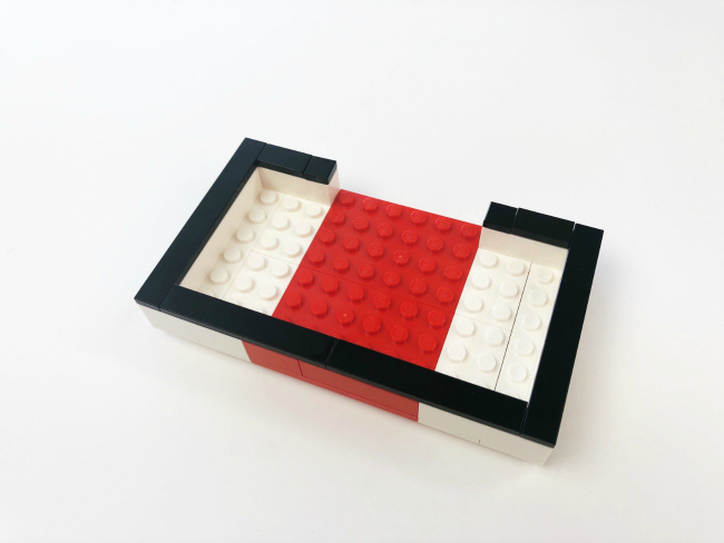 LEGO Fortnite Craft- -step 5- Place the 2 - 1X3 black tiles, 2 - 1X8 black tiles, and 2 - 1X6 black tiles on top of the bricks. - kids activities blog