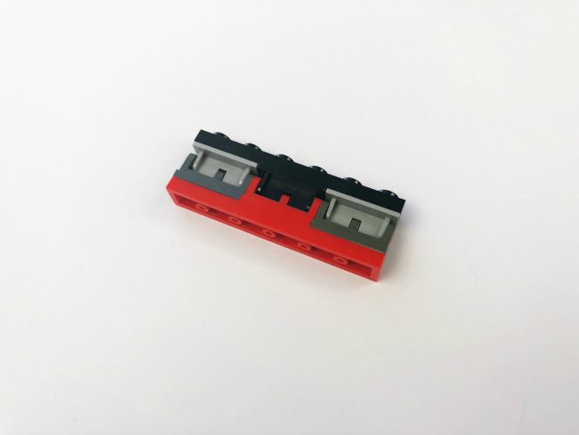 LEGO Fortnite Craft- -step 7- Place a 1X6 black plate onto the top of the hinges. - kids activities blog