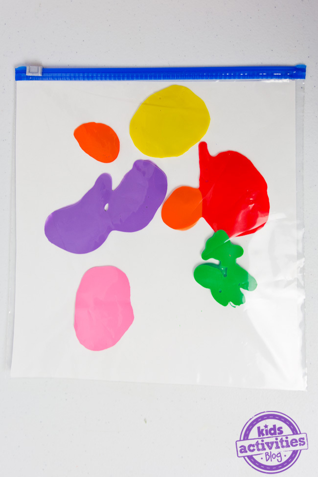 No Mess Finger Painting step 2 - cardboard inside the plastic bag with paint splotches added