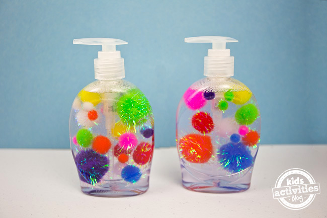Make kids want to wash their hands with this toddler soap idea by adding sparkling pom poms to clear liquid soap bottles.