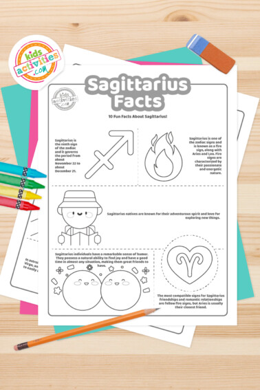 Black and white coloring pages with Sagittarius facts lying on top of a blue-green sheet with multicolored letters on a light brown background.