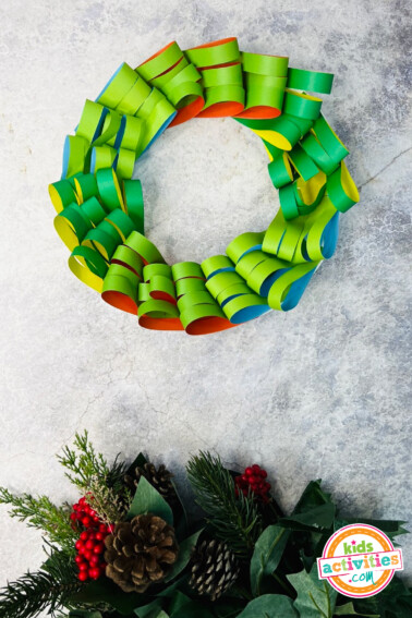 Image shows the final simple christmas wreath craft. from Kids activities blog