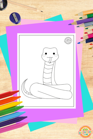 Black mamba coloring page on wooden background with various coloring supplies and accessories- kids activities blog
