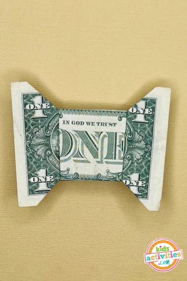 Finished result for a dollar bill origami bow tie. tutorial from kids activities blog