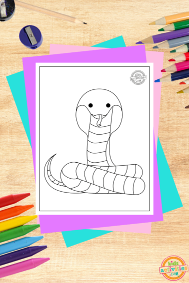 King cobra coloring page pdf file on wooden background with coloring supplies- kids activities blog